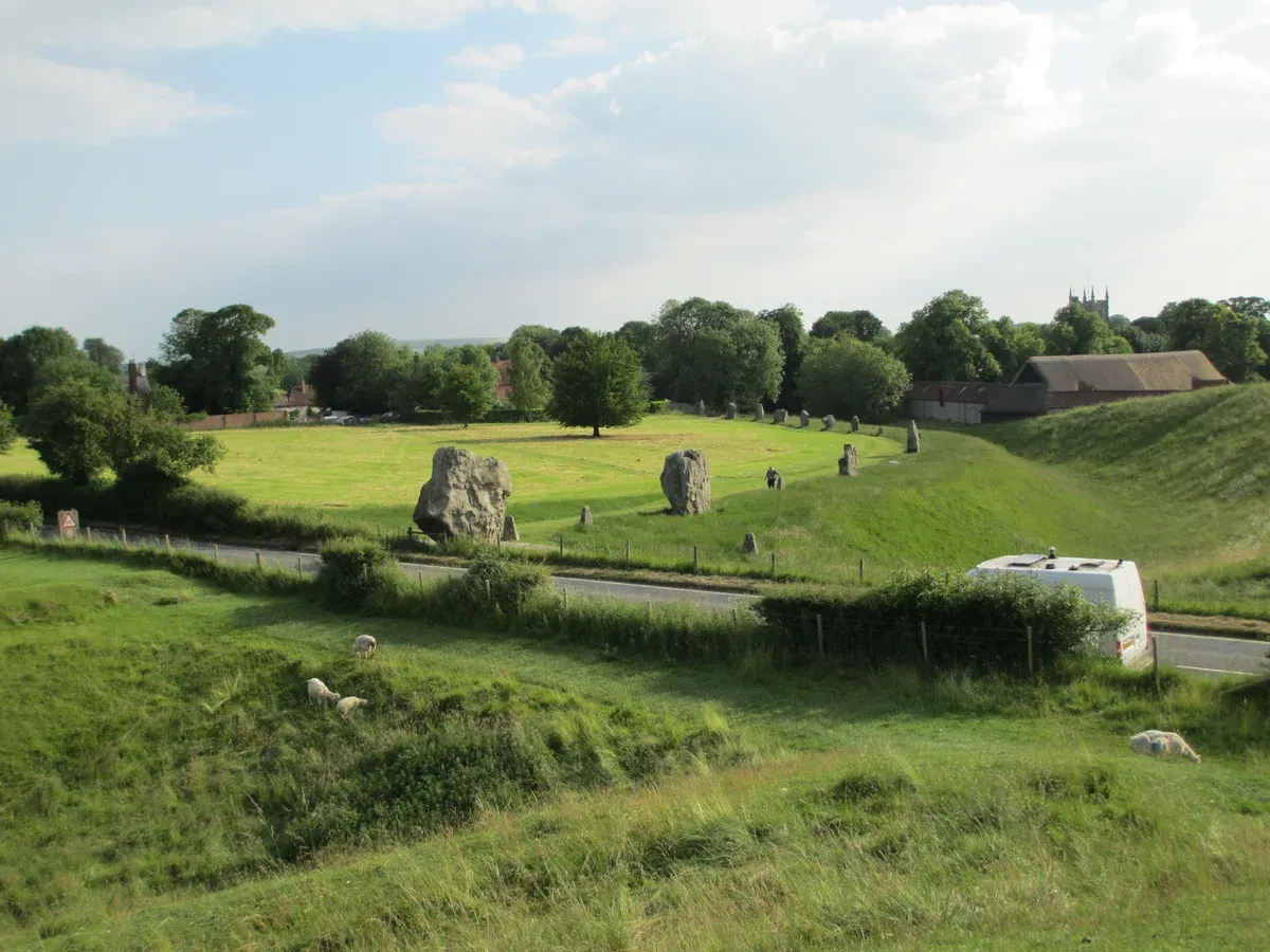 Standing stones of Avebury with the village behind, on a Stonehenge tour from London, Wiltshire