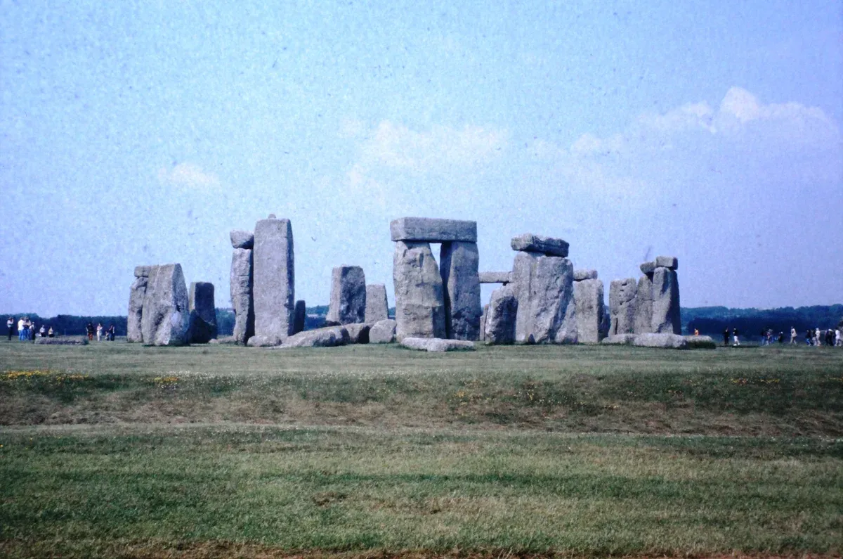 Visitors standing back from the stone circle on a Stonehenge tour from London, Wiltshire